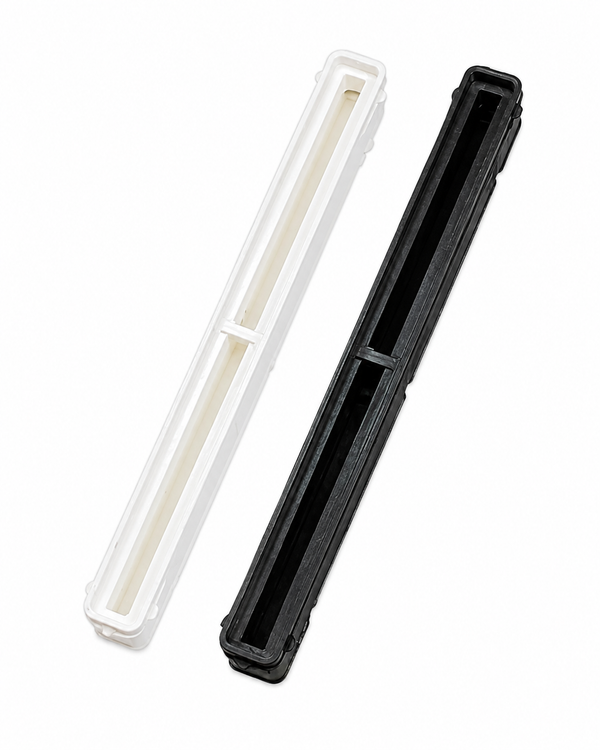 Black and white 10.5 inch Bahne center fin boxes with resin reservoirs.
