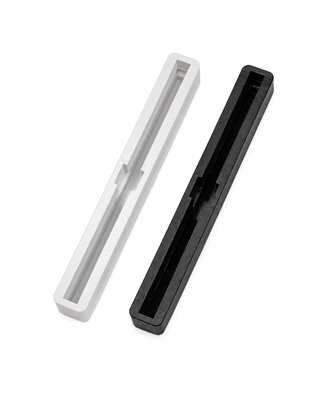 Black and white 6.75 inch Bahne fin boxes for surfboard center fin installation.