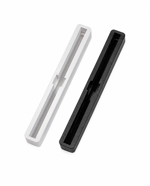 Black and white 6.75 inch Bahne fin boxes for surfboard center fin installation.