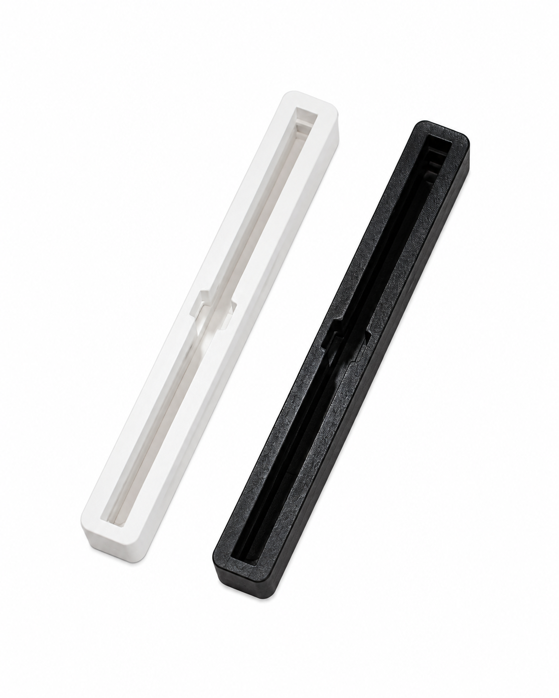 Black and white 7.5 inch Bahne center fin boxes for surfboard installation.
