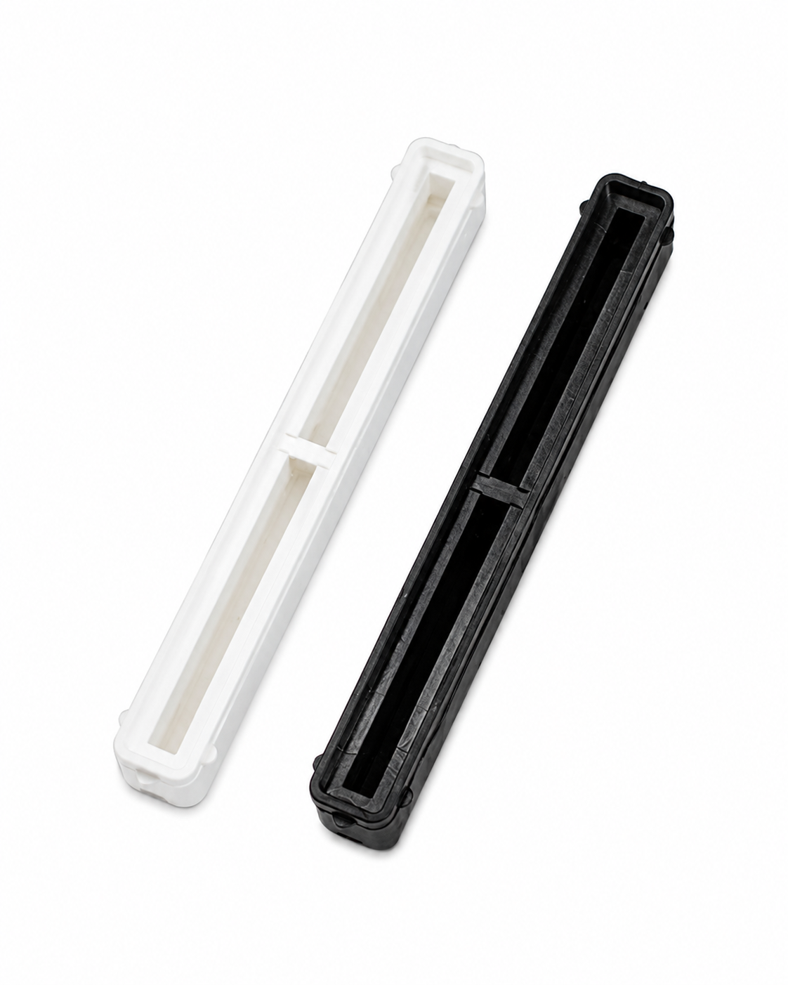 Black and white 8.5 inch Bahne center fin boxes with resin reservoirs.