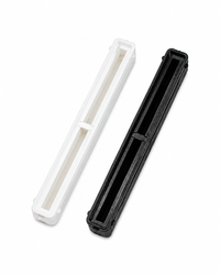 Black and white 8.5 inch Bahne center fin boxes with resin reservoirs.
