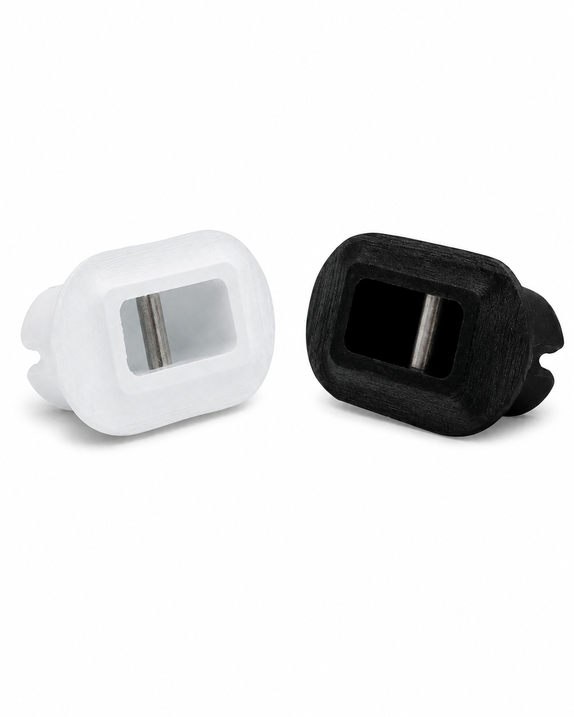 Genuine Futures pre-laminate surfboard leash plugs in black and white with integrated bonding flanges
