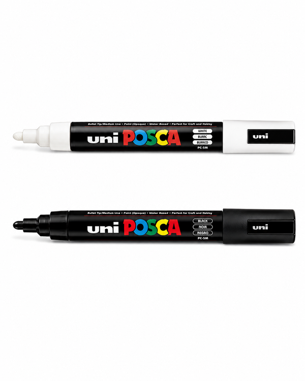 Black and white POSCA PC-5M medium tip paint markers for detailed surfboard artwork